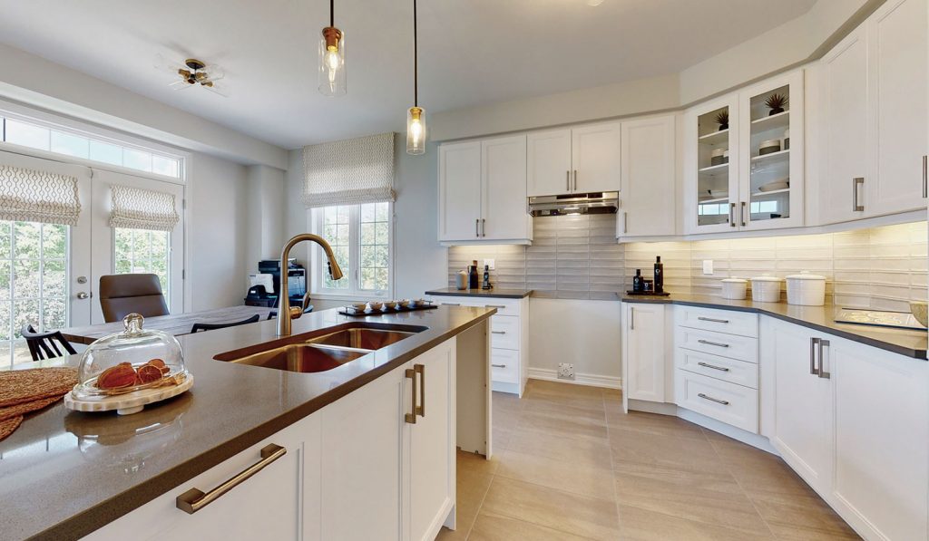 Picture Homes Model Home - Kitchen Cupboards and Drawers beside Island with Double Sink