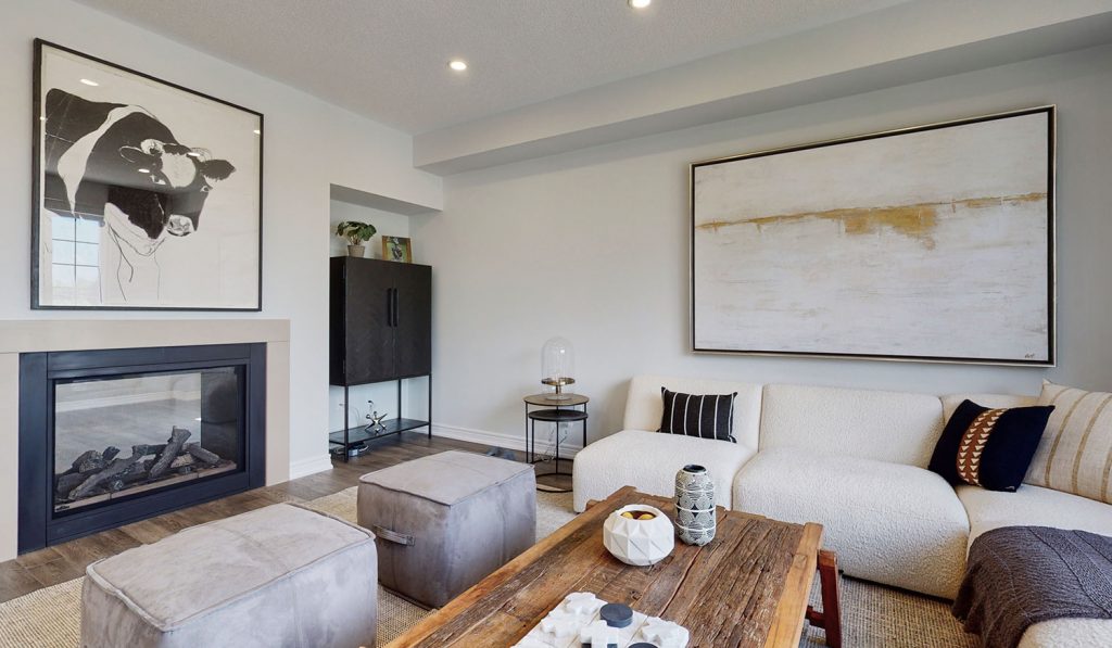 Picture Homes Model Home - Artwork Above Couch in Family Room in Front of Cozy Fire Place