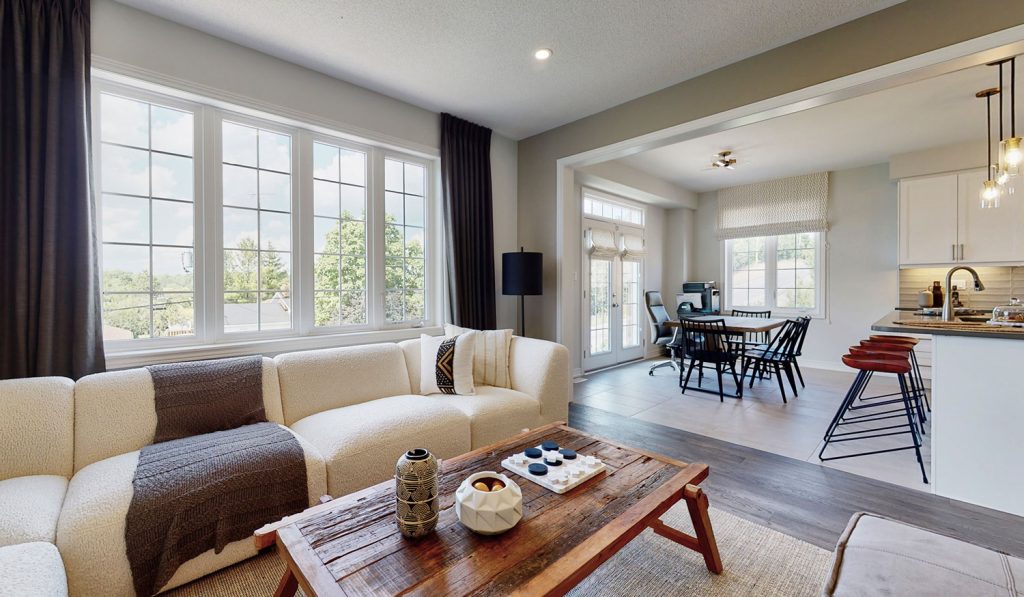 Picture Homes Model Home - Couch in Family Living Room with Wooden Table and Kitchen in Background