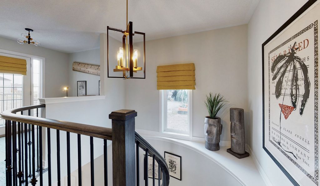 Picture Homes Model Home - Light Fixture Hanging Above Staircase With Artwork on the Ledge