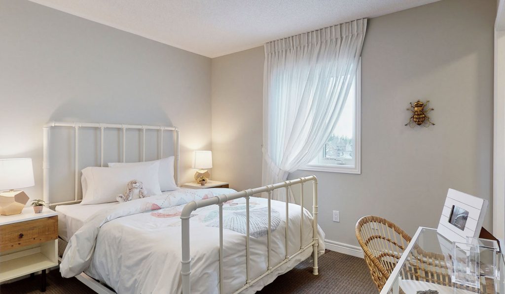 Picture Homes Model Home - Childs Bedroom with White Bed Beside the Window