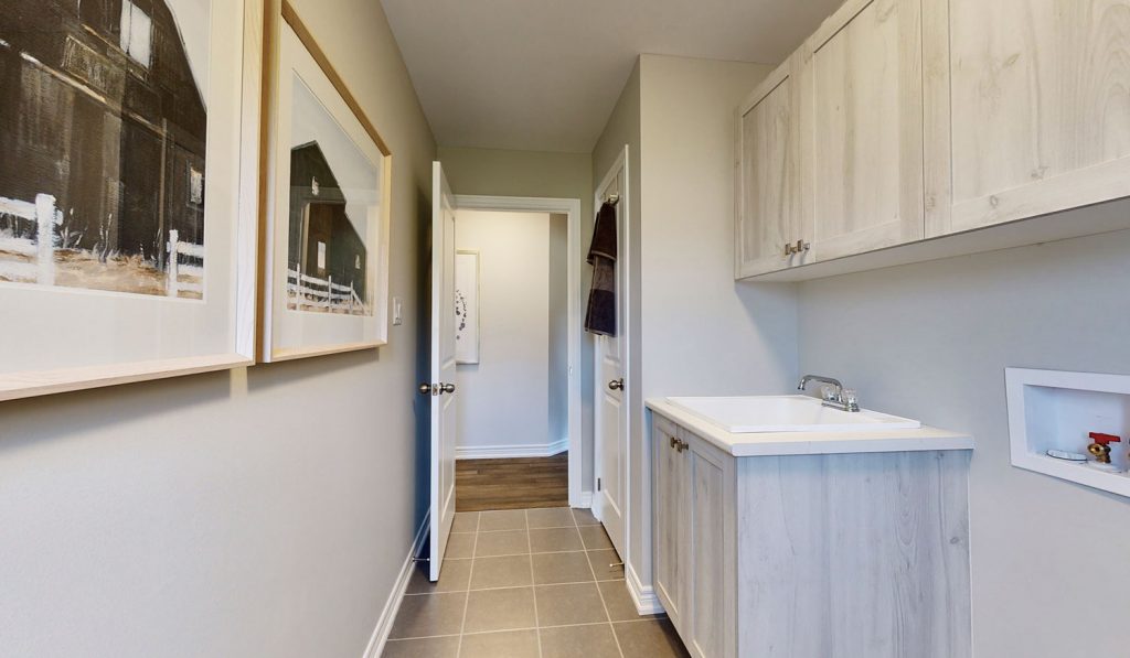 Picture Homes Model Home - Laundry Room with Sink and Storage Closet