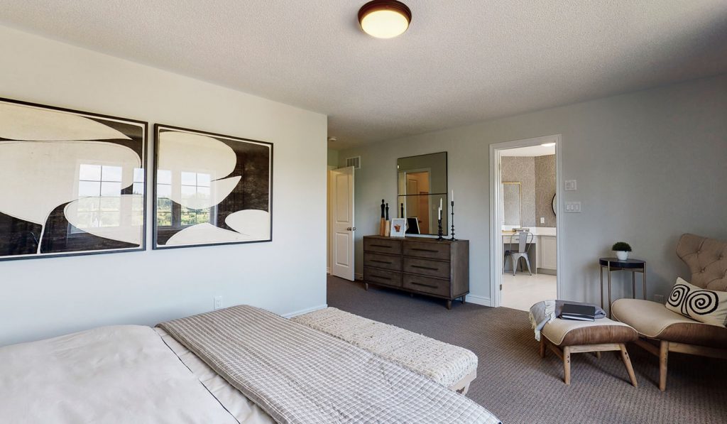 Picture Homes Model Home - Bedroom with Dresser and Chair in Front of Bed