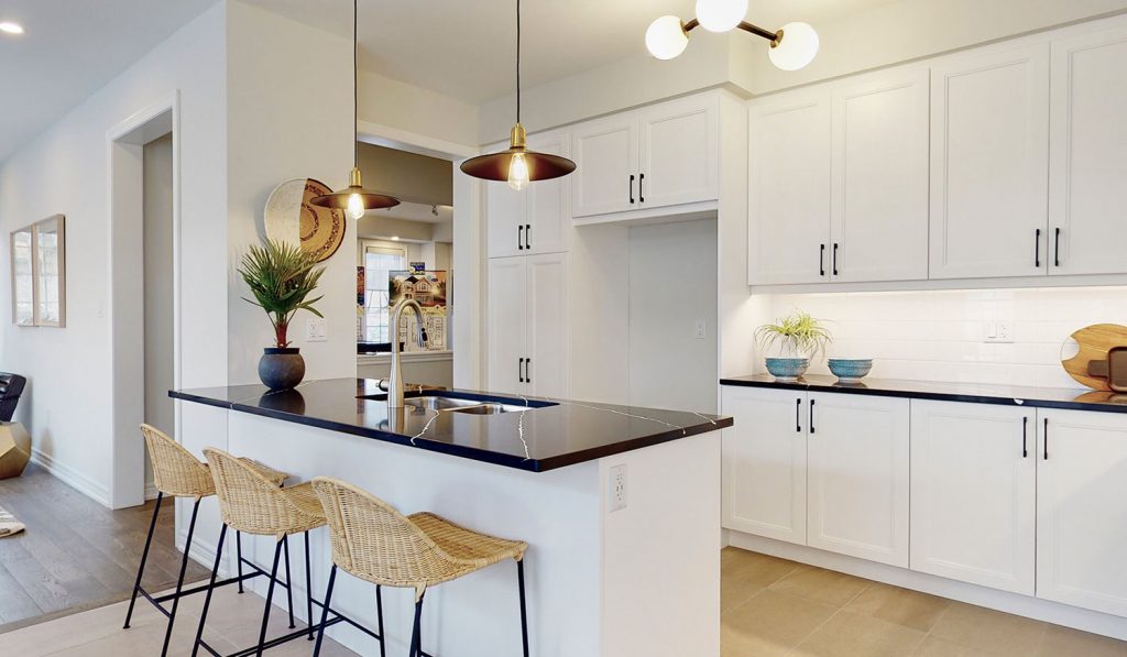 Picture Homes The Hampton Model Home - Kitchen Island with Seating in Front of Cabinetry