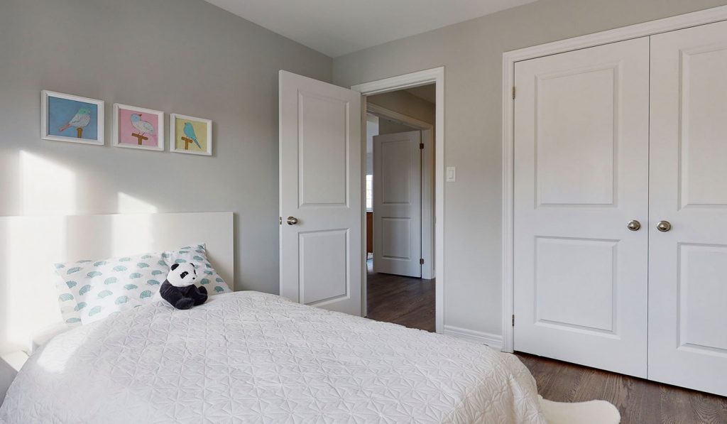 Picture Homes The Hampton Model Home - Bed and Double Closet Beside Bedroom Entrance Door